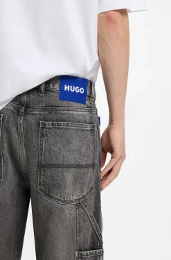 Baggy-fit black jeans with carpenter details