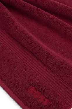 Cotton bath mat with embroidered logo