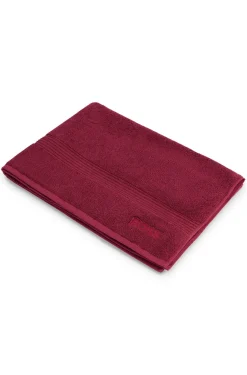 Cotton bath mat with embroidered logo