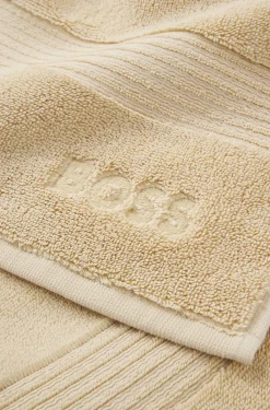 Cotton bath mat with embroidered logo