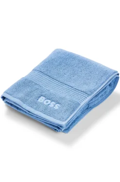 Cotton bath mat with embroidered logo