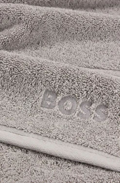 Cotton bath towel in silver with embroidered logo