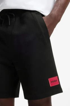Cotton-terry shorts with red logo label