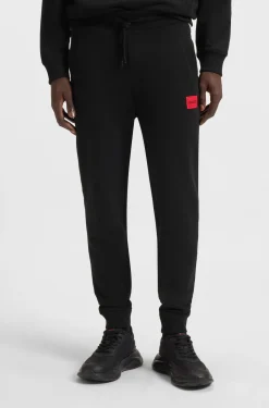 Cotton-terry tracksuit bottoms with red logo label