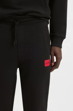 Cotton-terry tracksuit bottoms with red logo label