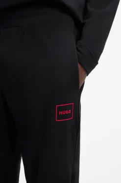 Cuffed loungewear bottoms in stretch cotton with logo print