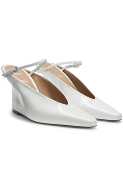 Glossy leather mules with wedge heel and strap