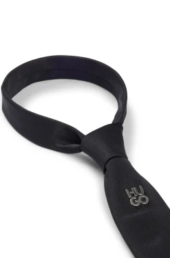 Jacquard-woven tie with metallic stacked-logo trim