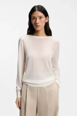 Knitted cardigan with rear button closure