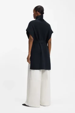 Knitted poncho in virgin wool with high neckline