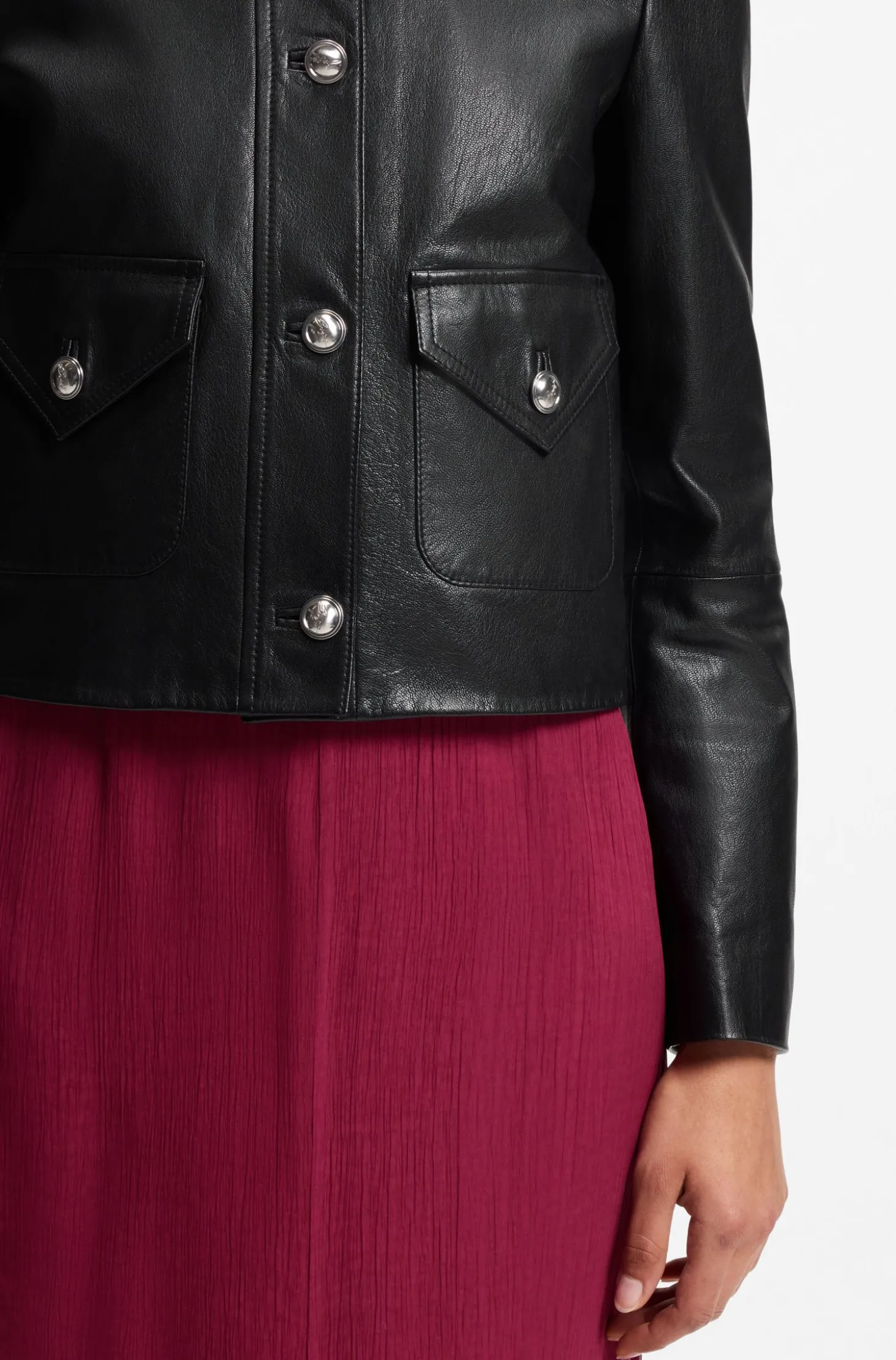 Leather jacket with polished logo buttons