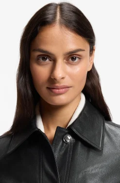 Leather jacket with polished logo buttons
