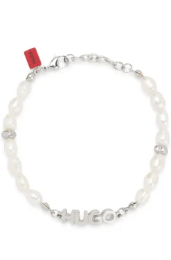 Pearl cuff with metal logo plaque