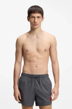 Quick-drying swim shorts with red logo label