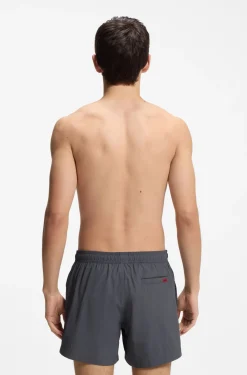 Quick-drying swim shorts with red logo label