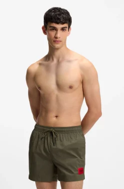 Quick-drying swim shorts with red logo label