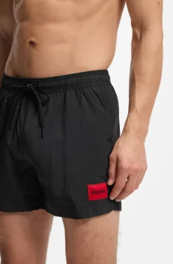 Quick-drying swim shorts with red logo label
