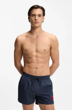 Quick-drying swim shorts with red logo label