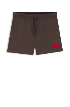 Quick-drying swim shorts with red logo label