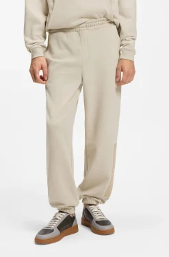 Relaxed-fit tracksuit bottoms in cotton with logo trim