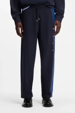 Relaxed-fit tracksuit bottoms in cotton with side stripe