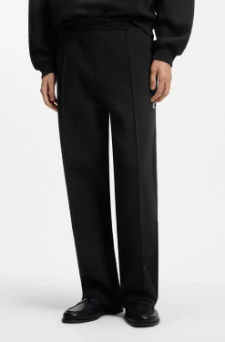 Relaxed-fit tracksuit bottoms in a structured cotton blend