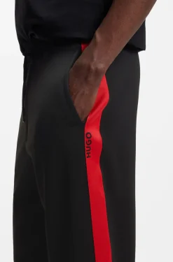 Relaxed-fit tracksuit bottoms with logo tape
