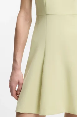 Sleeveless dress with gold-tone flower brooch