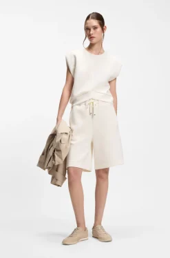 Sleeveless loose-fit sweatshirt with V-cut hemline