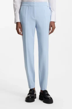 Slim-fit trousers in stretch fabric with logo rivet