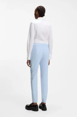 Slim-fit trousers in stretch fabric with logo rivet