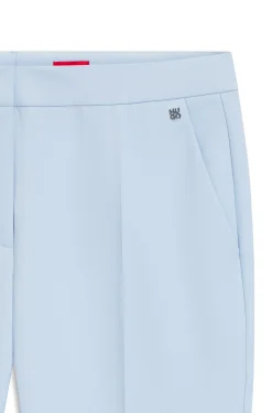 Slim-fit trousers in stretch fabric with logo rivet