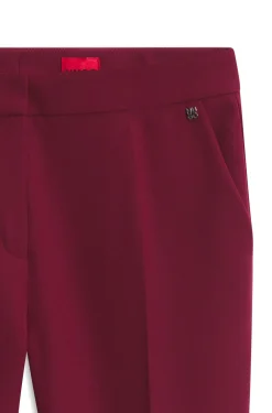 Slim-fit trousers in stretch fabric with logo rivet