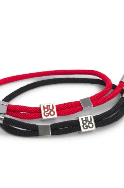 Two-pack of cord cuffs with logo plaques