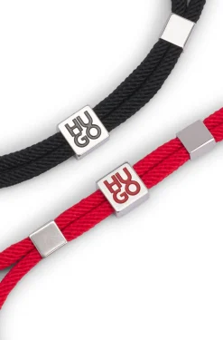 Two-pack of cord cuffs with logo plaques