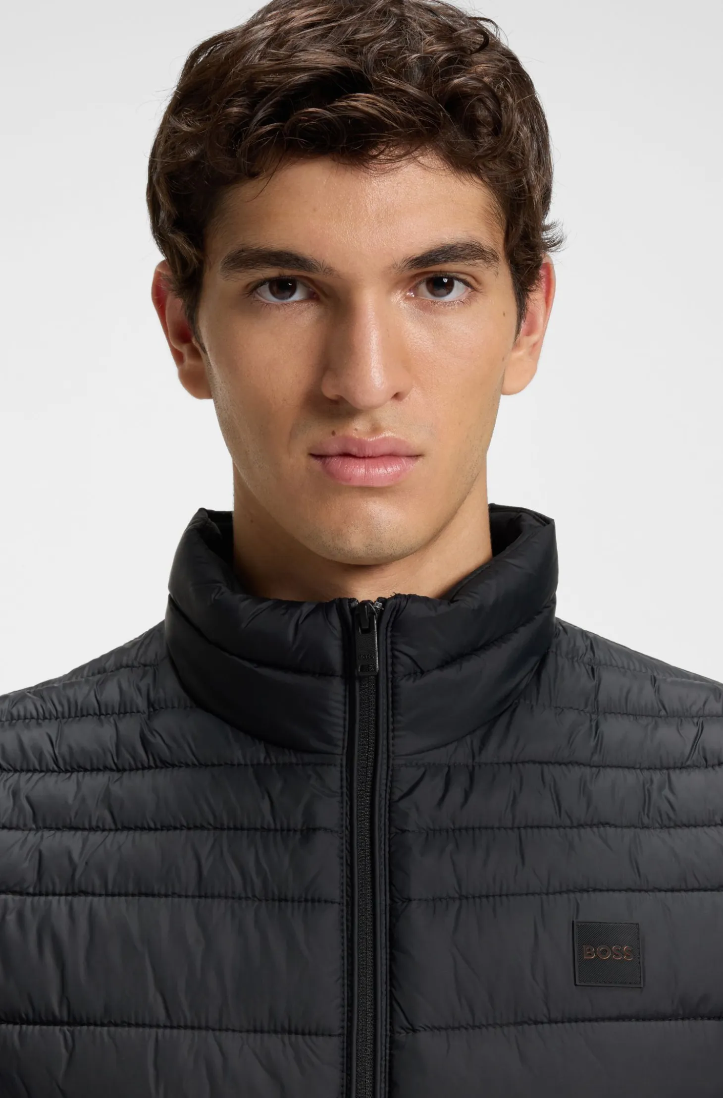 Water-repellent gilet with logo patch