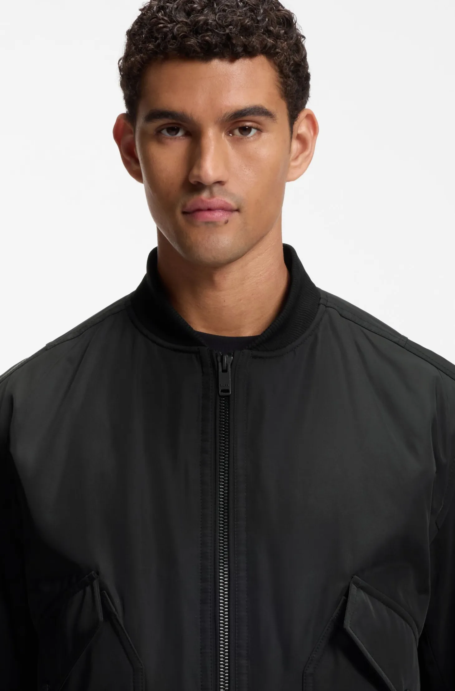 Water-repellent jacket with detachable hooded bib