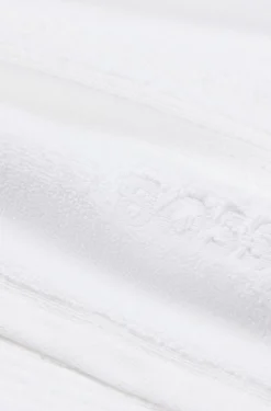 White cotton guest towel with embroidered logo